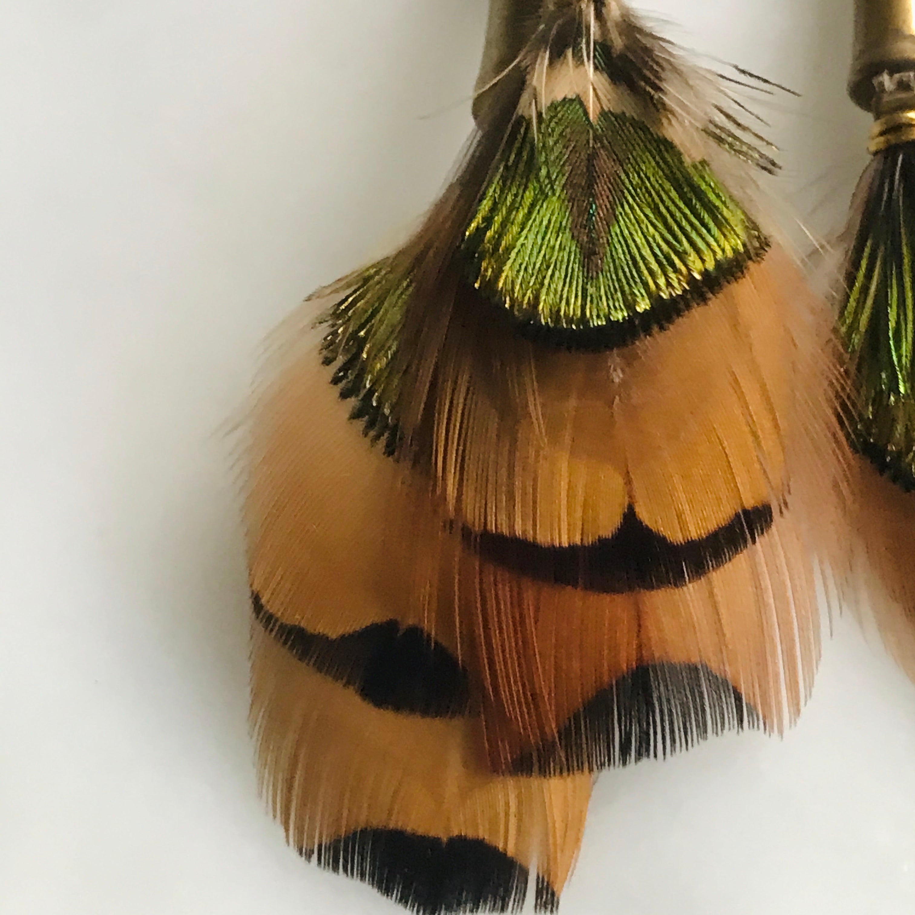feather, braided leather and brass earrings