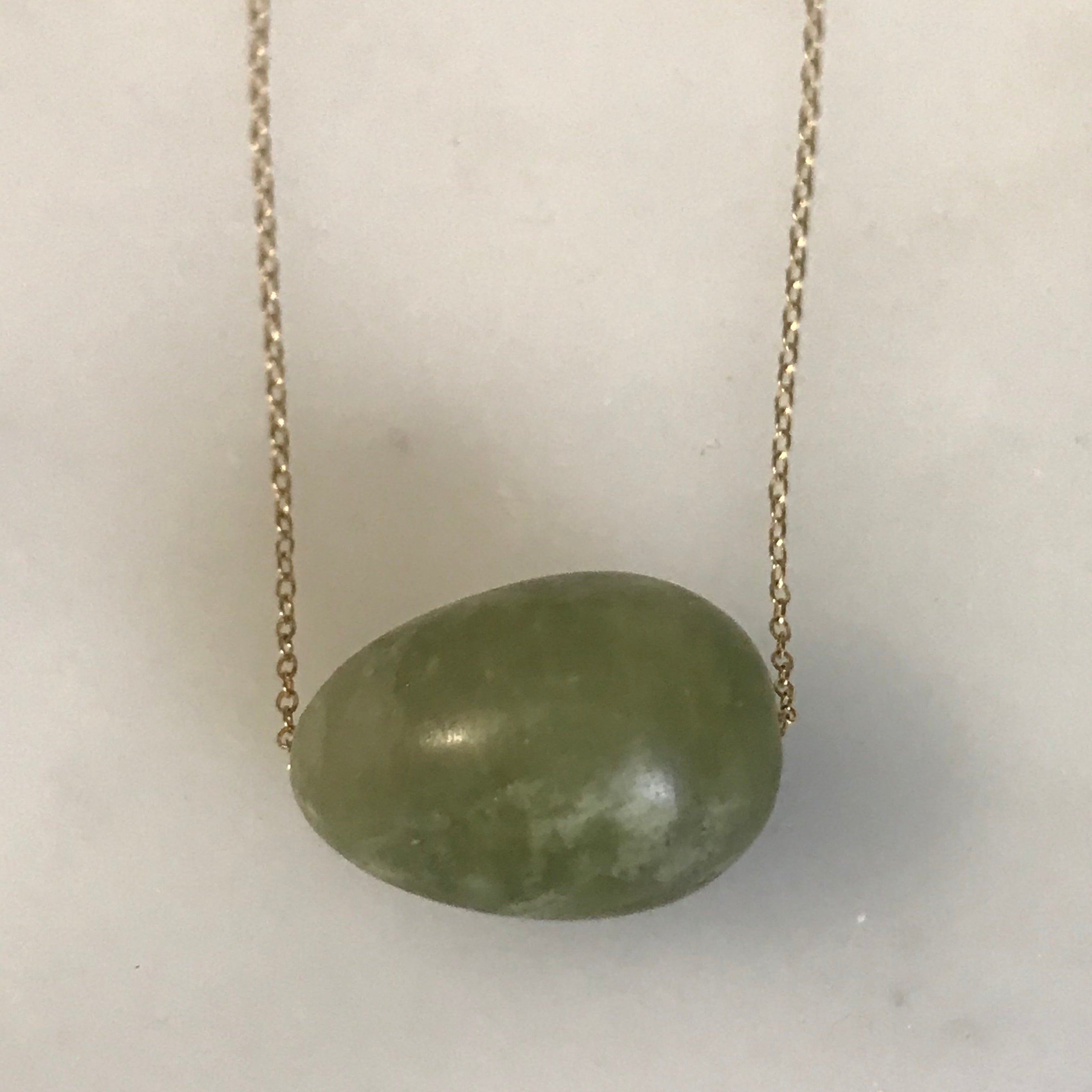 floating matte green garnet egg on 14k gold chain