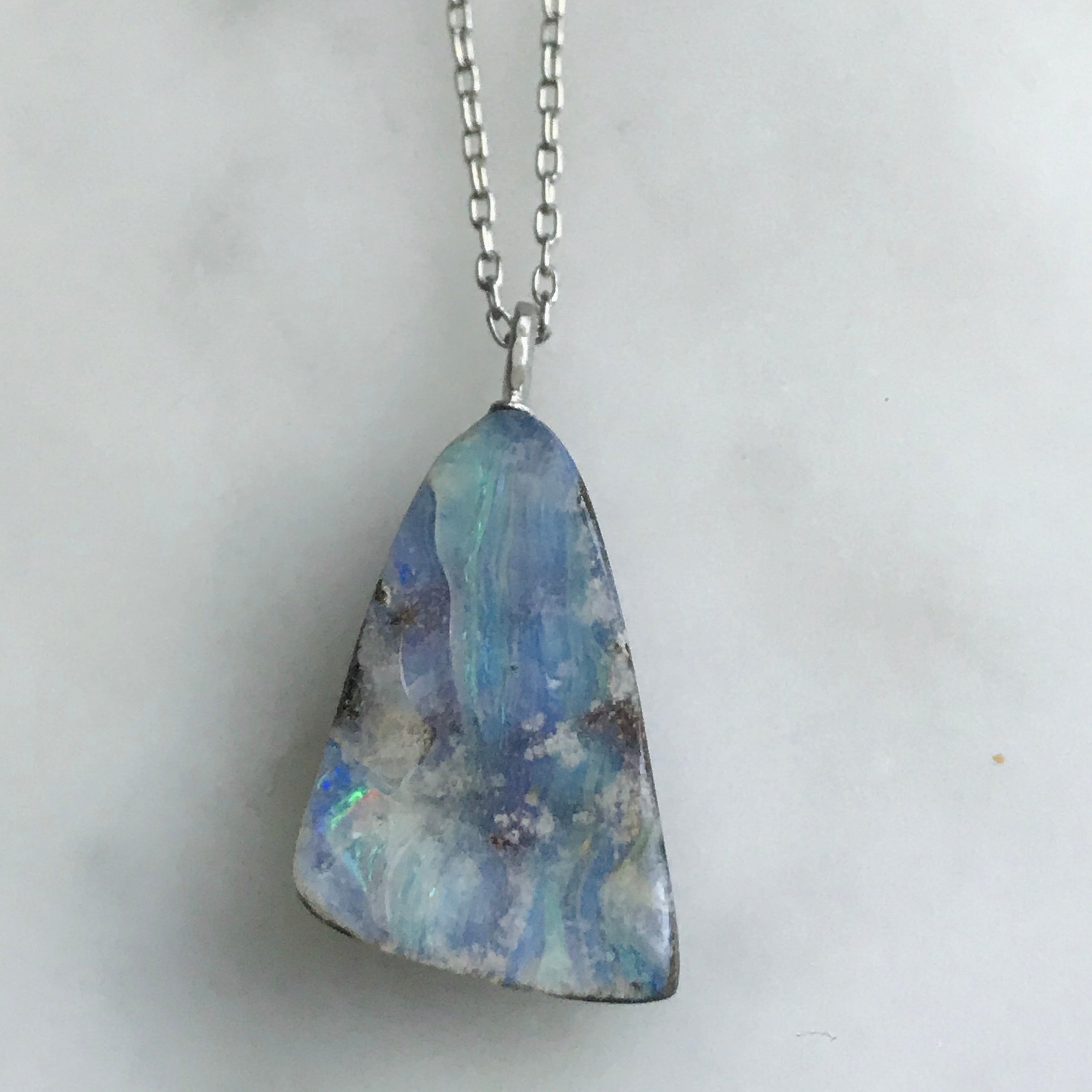 triangle shaped boulder opal on an 18” 14k white gold chain